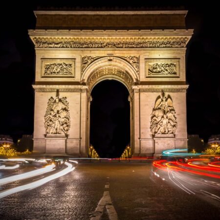 Arc de triomphe at night with moving lights from traffic